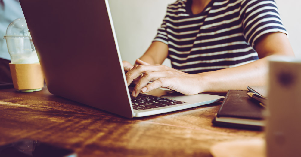 women typing on computer