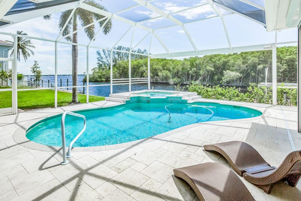 Screened pool and lanai overlooking a canal at a VueStay Southwest Florida vacation rental