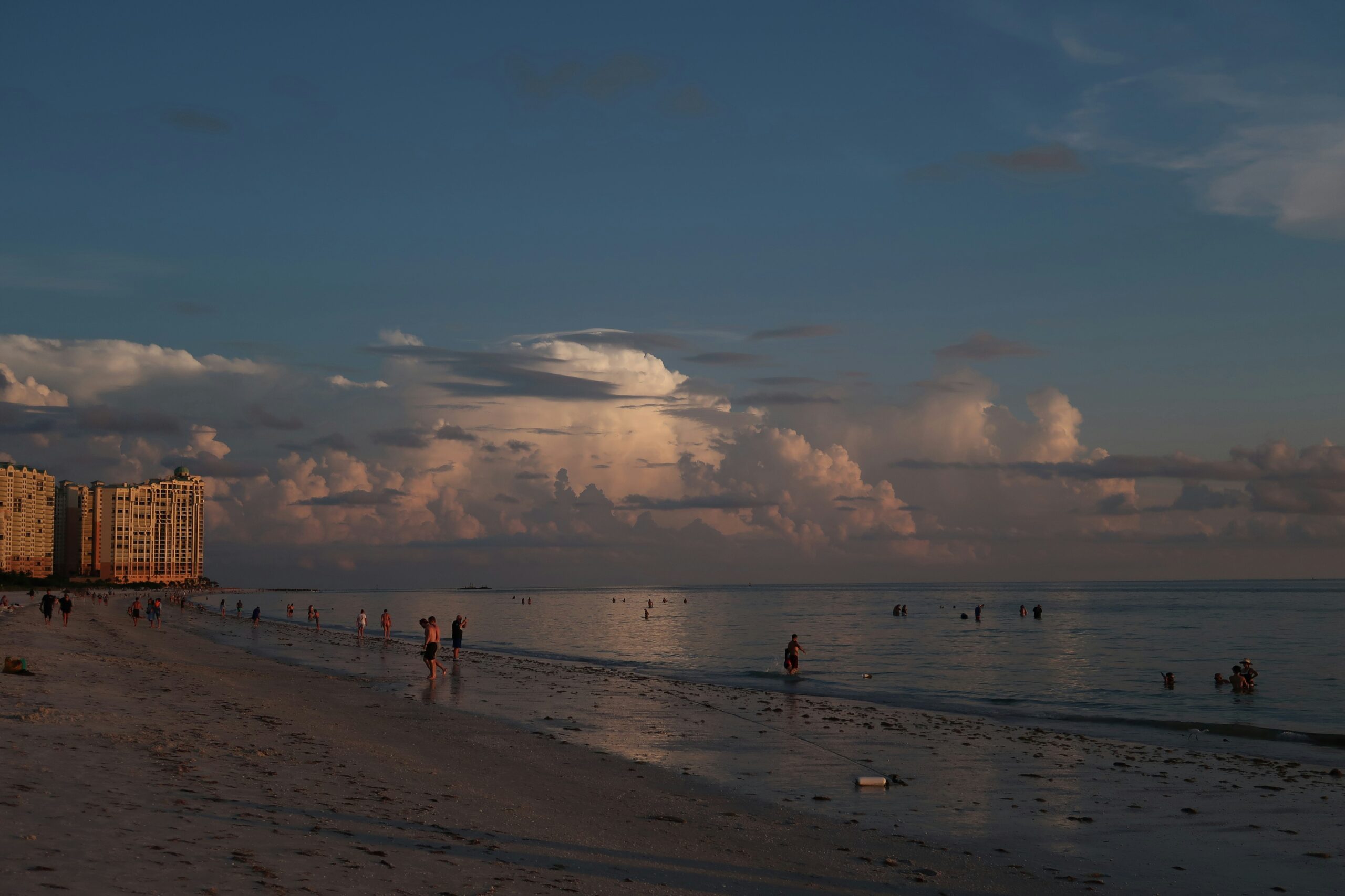 Sunset over the Gulf with Marco Island's beachfront towers and storm clouds