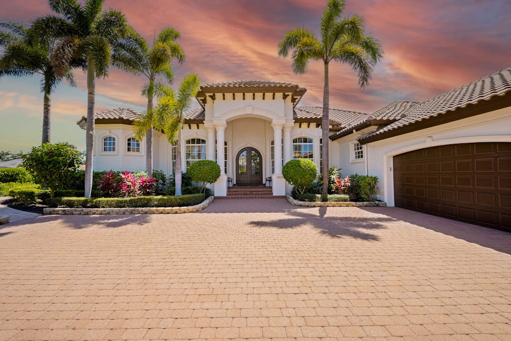 VueStay vacation home exterior at sunset with palm-lined entrance