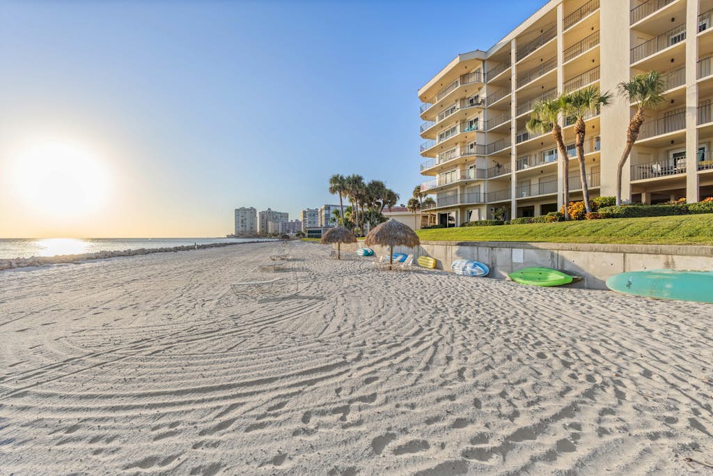 Beach cabanas and sand at a Marco Island beachfront condo